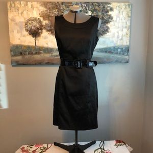 Black round neck satin finish sleeveless dress with patent leather wide belt